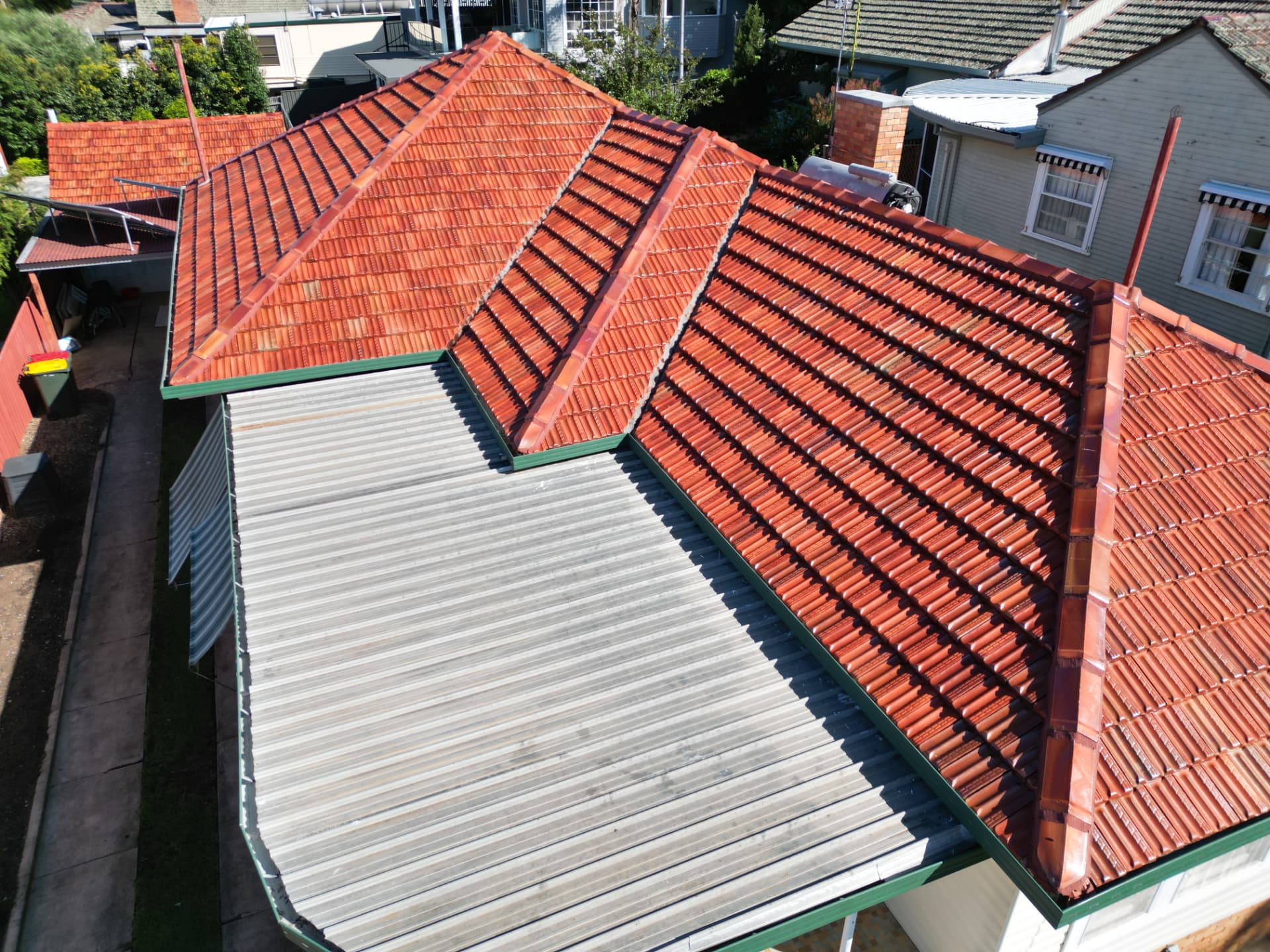 Terracotta tile roof cleaned and sealed back to its natural colour